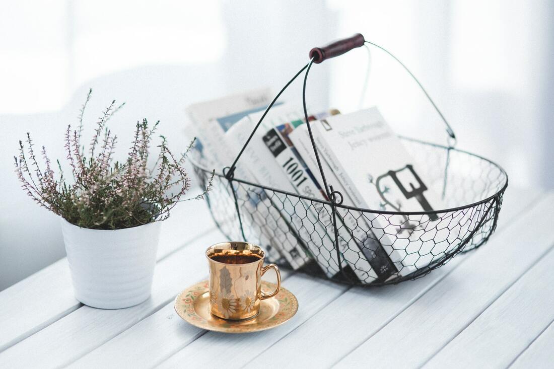 Basket, plant, and brass cup interior design coffee table