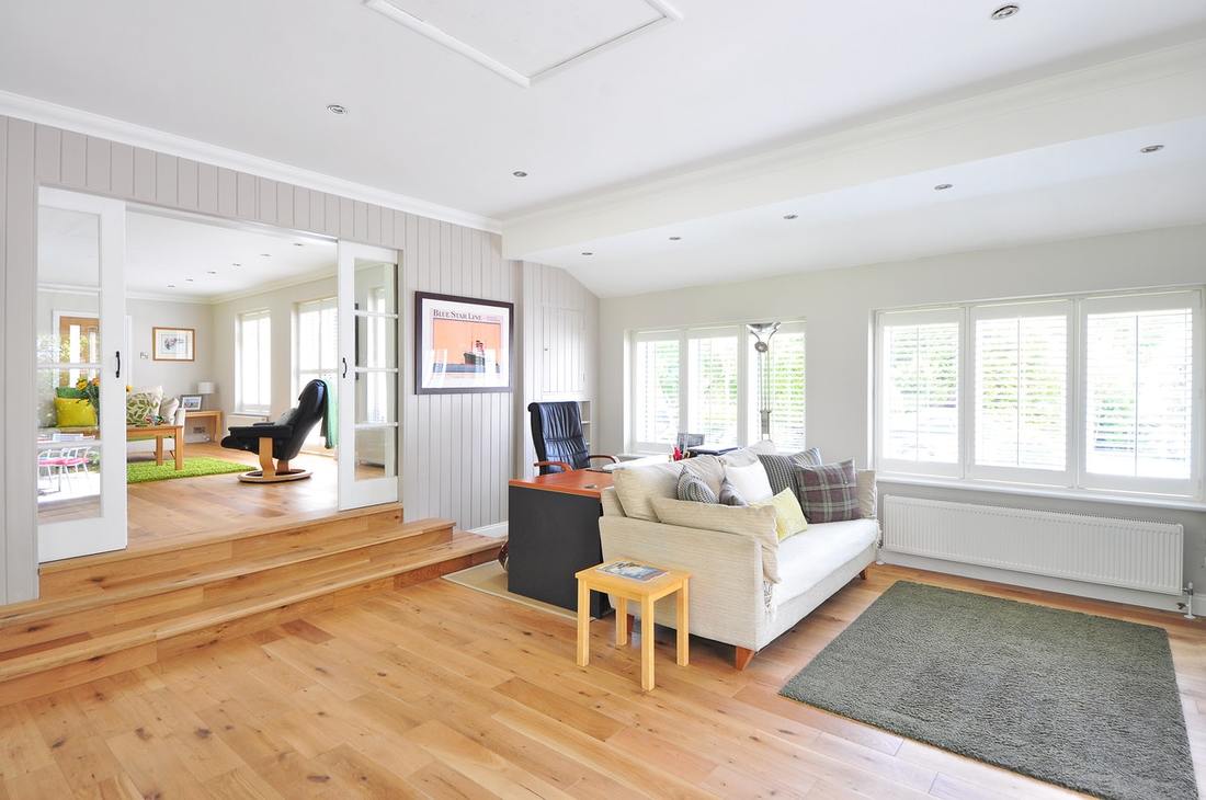 Sunken living room with wood floors and white walls